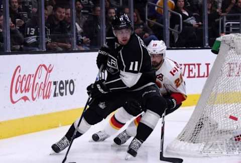 Mar 31, 2016; Los Angeles, CA, USA; Los Angeles Kings center Anze Kopitar (11) skates with the puck as Calgary Flames defenseman Deryk Engelland (29) chases in the second period during at Staples Center. Mandatory Credit: Kirby Lee-USA TODAY Sports