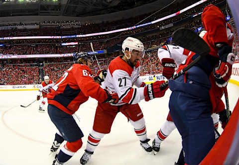 WASHINGTON, DC – APRIL 20: Washington Capitals left wing Carl Hagelin (62) hits Carolina Hurricanes defenseman Justin Faulk (27) in the first period on April 20, 2019, at the Capital One Arena in Washington, D.C. in the first round of the Stanley Cup Playoffs. (Photo by Mark Goldman/Icon Sportswire via Getty Images)