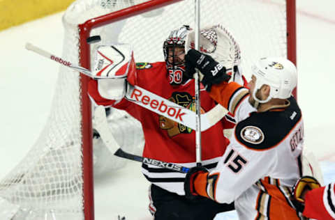 CHICAGO, IL: Ryan Getzlaf #15 of the Anaheim Ducks tries to deflect the puck against Corey Crawford #50 of Chicago in the first overtime period of Game Four of the 2015 Western Conference Finals on May 23, 2015. (Photo by Tasos Katopodis/Getty Images)