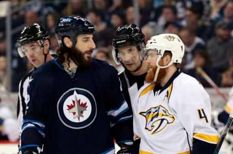 Apr 8, 2017; Winnipeg, Manitoba, CAN; Winnipeg Jets right wing Chris Thorburn (22) and Nashville Predators defenseman Ryan Ellis (4) talk during a time out in the second period at MTS Centre. Winnipeg Jets 2-1 over Nashville Predators. Mandatory Credit: James Carey Lauder-USA TODAY Sports