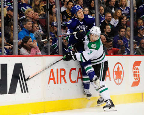 Nov 17, 2013; Vancouver, British Columbia, CAN; Vancouver Canucks forward Mike Santorelli (25) is boarded by Dallas Stars defenseman Stephane Robidas (3) during the first period at Rogers Arena. Mandatory Credit: Anne-Marie Sorvin-USA TODAY Sports