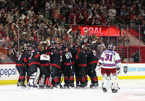 RALEIGH, NORTH CAROLINA – MAY 18: Ian Cole #28 of the Carolina Hurricanes scores at 3:12 of overtime against Igor Shesterkin #31 of the New York Rangers in Game One of the Second Round of the 2022 Stanley Cup Playoffs at PNC Arena on May 18, 2022 in Raleigh, North Carolina. The Hurricanes defeated the Rangers 2-1 in overtime. (Photo by Bruce Bennett/Getty Images)