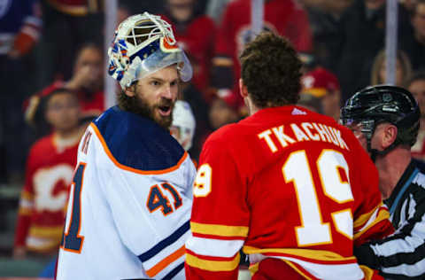 Edmonton Oilers goaltender Mike Smith (41) and Calgary Flames left wing Matthew Tkachuk (19) exchanges words. Mandatory Credit: Sergei Belski-USA TODAY Sports