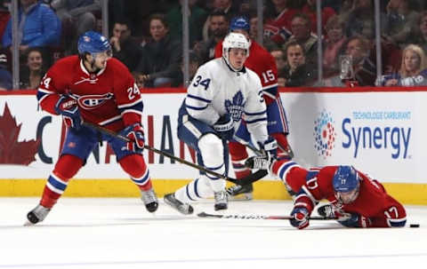 Nov 19, 2016; Montreal, Quebec, CAN; Montreal Canadiens center Torrey Mitchell (17) falls on the ice after battling for the puck with Toronto Maple Leafs center Auston Matthews (34) and left wing Phillip Danault (24) during the second period at Bell Centre. Mandatory Credit: Jean-Yves Ahern-USA TODAY Sports