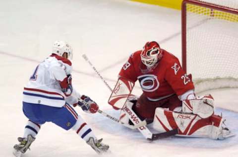 RALEIGH, NC – DECEMBER 31: Goalie Martin Gerber #29 of the Carolina Hurricanes stops a breakaway shot by Mike Ribeiro #71 of the Montreal Canadiens during the third period of their NHL game on December 31, 2005, at the RBC Center in Raleigh, North Carolina. The Hurricanes defeated the Canadiens 5-3. (Photo By Grant Halverson/Getty Images)