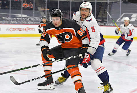 Mar 13, 2021; Philadelphia, Pennsylvania, USA; Philadelphia Flyers defenseman Justin Braun (61) and Washington Capitals left wing Alex Ovechkin (8) battle for the puck during the second period at Wells Fargo Center. Mandatory Credit: Eric Hartline-USA TODAY Sports