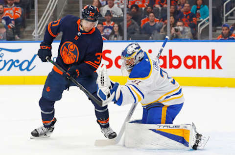 Oct 18, 2022; Edmonton, Alberta, CAN; Edmonton Oilers forward Warren Foegele (37) looks for a rebound in front of Buffalo Sabres goaltender Eric Comrie (31) during the first period at Rogers Place. Mandatory Credit: Perry Nelson-USA TODAY Sports