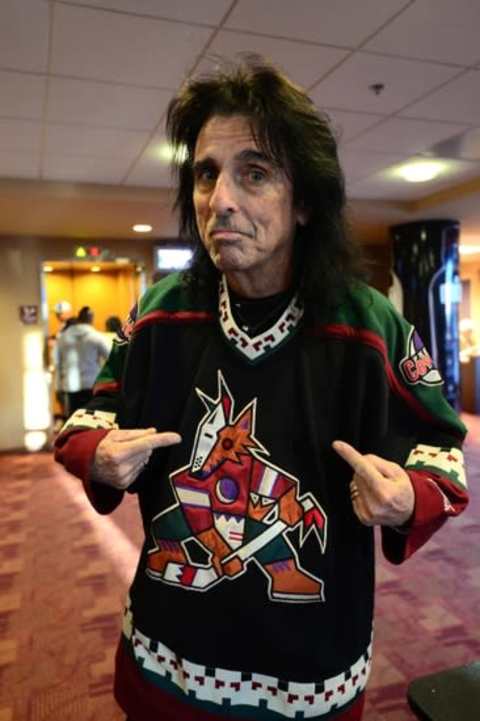 Mar 5, 2015; Glendale, AZ, USA; Recording artist Alice Cooper poses with his retro Arizona Coyotes jersey before a game against the Vancouver Canucks at Gila River Arena. Mandatory Credit: Joe Camporeale-USA TODAY Sports