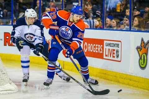 Feb 13, 2016; Edmonton, Alberta, CAN; Edmonton Oilers center Leon Draisaitl (29) and Winnipeg Jets defenseman Tyler Myers (57) battle for the puck during the second period at Rexall Place. Mandatory Credit: Sergei Belski-USA TODAY Sports