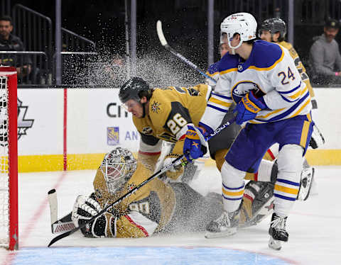 LAS VEGAS, NEVADA – FEBRUARY 01: Robin Lehner #90 and Mattias Janmark #26 of the Vegas Golden Knights fall to the iceas they defend the net as Dylan Cozens #24 of the Buffalo Sabres looks on in the third period of their game at T-Mobile Arena on February 1, 2022 in Las Vegas, Nevada. The Golden Knights defeated the Sabres 5-2. (Photo by Ethan Miller/Getty Images)