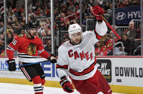 CHICAGO, IL – NOVEMBER 19: Nino Niederreiter #21 of the Carolina Hurricanes celebrates as Erik Gustafsson #56 of the Chicago Blackhawks reacts after Niederreiter scored in the second period at the United Center on November 19, 2019 in Chicago, Illinois. (Photo by Bill Smith/NHLI via Getty Images)