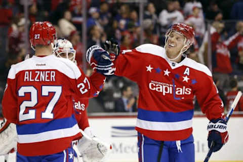 Feb 4, 2016; Washington, DC, USA; Washington Capitals defenseman John Carlson (74) celebrates with Capitals defenseman Karl Alzner (27) after their game against the New York Islanders at Verizon Center. The Capitals won 3-2. Mandatory Credit: Geoff Burke-USA TODAY Sports