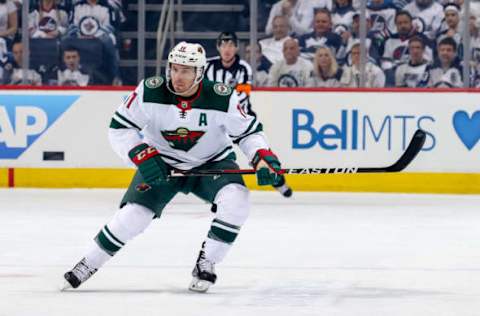 WINNIPEG, MB – APRIL 13: Zach Parise #11 of the Minnesota Wild keeps an eye on the play during first period action against the Winnipeg Jets in Game Two of the Western Conference First Round during the 2018 NHL Stanley Cup Playoffs at the Bell MTS Place on April 13, 2018 in Winnipeg, Manitoba, Canada. The Jets defeated the Wild 4-1 to lead the series 2-0. (Photo by Jonathan Kozub/NHLI via Getty Images)