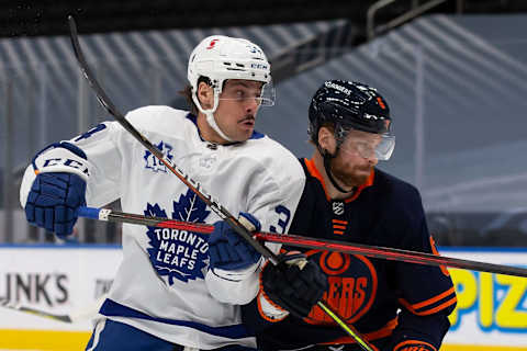 EDMONTON, AB – JANUARY 28: Adam Larsson #6 of the Edmonton Oilers battles against Auston Matthews #34 of the Toronto Maple Leafs . (Photo by Codie McLachlan/Getty Images)