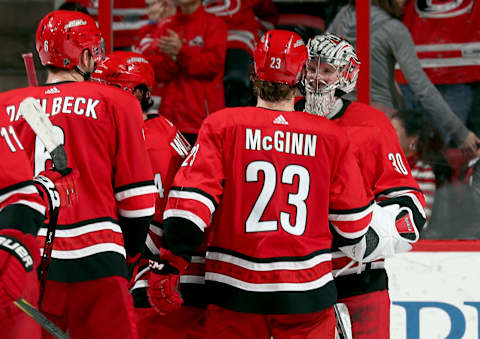 RALEIGH, NC – DECEMBER 23: Members of the Carolina Hurricanes surround Cam Ward #30 following their 4-2 victory over the Buffalo Sabres during an NHL game on December 23, 2017 at PNC Arena in Raleigh, North Carolina. (Photo by Gregg Forwerck/NHLI via Getty Images)