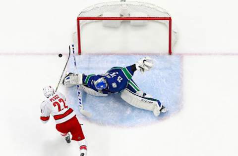 VANCOUVER, BC – DECEMBER 12: Jacob Markstrom #25 of the Vancouver Canucks makes a save against Brett Pesce #22 of the Carolina Hurricanes during their NHL game at Rogers Arena December 12, 2019 in Vancouver, British Columbia, Canada. Vancouver won 1-0. (Photo by Jeff Vinnick/NHLI via Getty Images)