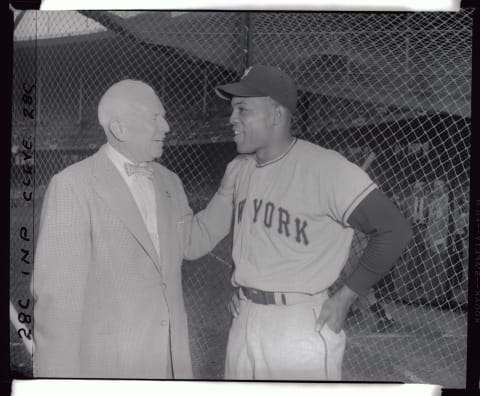 Tris Speaker, probably the greatest center fielder in baseball history, chats with the New York Giants ace center fielder Willie Mays. Modern baseball historians insist that Mays is the greatest of the generation.