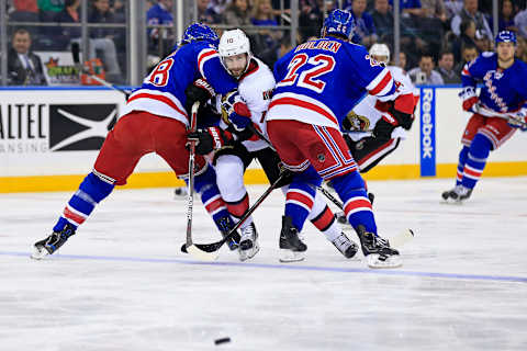 Dec 27, 2016; New York, NY, USA; Ottawa Senators left wing Tom Pyatt (10) gets caught between New York Rangers defenseman Nick Holden (22) and Rangers defenseman Marc Staal (18) during the first period at Madison Square Garden. Mandatory Credit: Adam Hunger-USA TODAY Sports