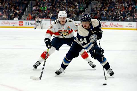 COLUMBUS, OH – NOVEMBER 20: Trey Fix-Wolansky #64 of the Columbus Blue Jackets skates the puck away from Anton Lundell #15 of the Florida Panthers during the game at Nationwide Arena on November 20, 2022 in Columbus, Ohio. (Photo by Kirk Irwin/Getty Images)