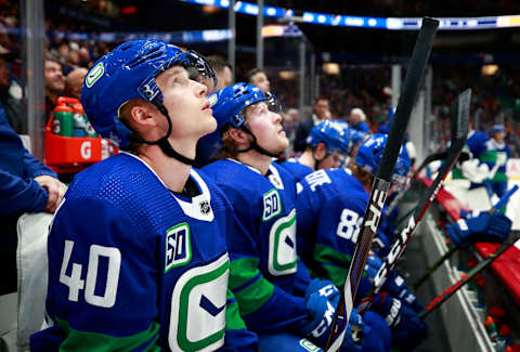 Elias Pettersson of the Vancouver Canucks looks on from the bench (Photo by Jeff Vinnick/NHLI via Getty Images)