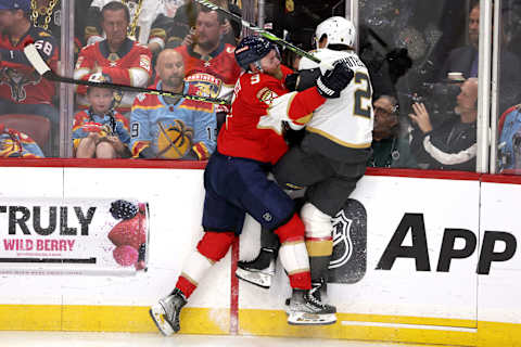 Sam Bennett #9 of the Florida Panthers checks Zach Whitecloud #2   (Photo by Patrick Smith/Getty Images)