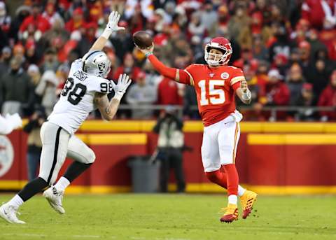 KANSAS CITY, MO – DECEMBER 01: Kansas City Chiefs quarterback Patrick Mahomes (15) throws a sidearm pass around Oakland Raiders defensive end Maxx Crosby (98) in the second quarter of an AFC West game between the Oakland Raiders and Kansas City Chiefs on December 1, 2019 at Arrowhead Stadium in Kansas City, MO. (Photo by Scott Winters/Icon Sportswire via Getty Images)