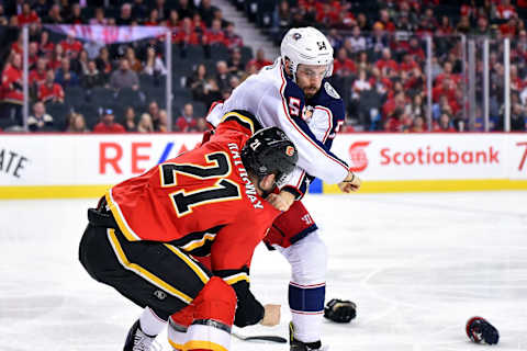 CALGARY, AB – MARCH 19: Calgary Flames Right Wing Garnet Hathaway (21) and Columbus Blue Jackets Defenceman Adam McQuaid (54) fight during the second period of an NHL game where the Calgary Flames hosted the Columbus Blue Jackets on March 19, 2019, at the Scotiabank Saddledome in Calgary, AB. (Photo by Brett Holmes/Icon Sportswire via Getty Images)