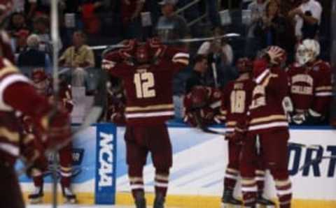 Apr 7, 2016; Tampa, FL, USA; Boston College Eagles forward Alex Tuch (12) and teammates react as they lose to the Quinnipiac Bobcats during the semifinals of the 2016 Frozen Four college ice hockey tournament at Amalie Arena. Quinnipiac Bobcats defeated the Boston College Eagles 3-2. Mandatory Credit: Kim Klement-USA TODAY Sports