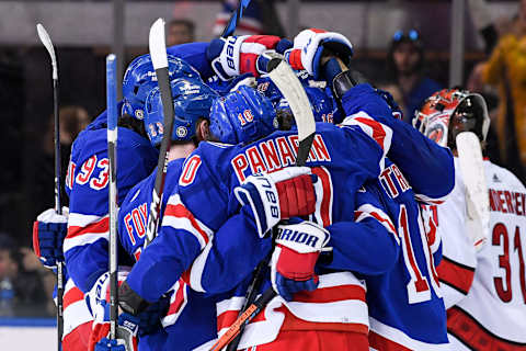 Apr 12, 2022; New York, New York, USA; New York Rangers players celebrate the 50th goal of the season by left wing Chris Kreider (20) against the Carolina Hurricanes during the third period at Madison Square Garden. Mandatory Credit: Dennis Schneidler-USA TODAY Sports