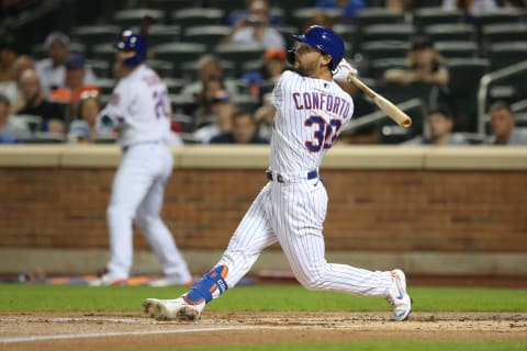 Sep 14, 2021; New York City, New York, USA; New York Mets right fielder Michael Conforto (30) follows through on an RBI single against the St. Louis Cardinals during the first inning at Citi Field. Mandatory Credit: Brad Penner-USA TODAY Sports