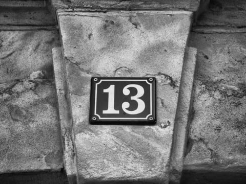 The number thirteen on a street placard