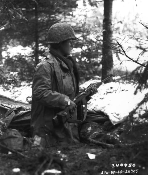 A 442nd squad leader looks for German movements in a French valley