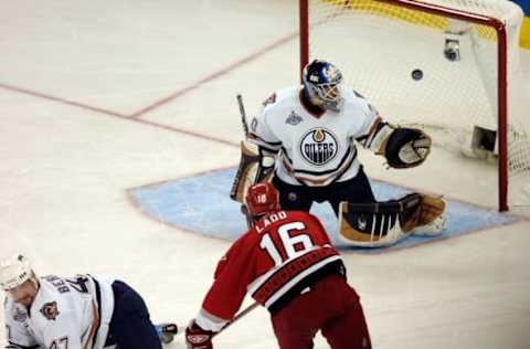 RALEIGH, NC – JUNE 07: Andrew Ladd #16 of the Carolina Hurricanes scores the first goal over goaltender Jussi Markkanen #30 and Marc-Andre Bergeron #47 of the Edmonton Oiler during the first period of game two of the 2006 NHL Stanley Cup Finals on June 7, 2006 at the RBC Center in Raleigh, North Carolina. (Photo by Grant Halverson/Getty Images)