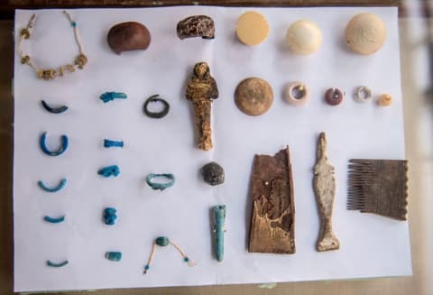 Jewelry, statues, and other artifacts discovered in the tomb.