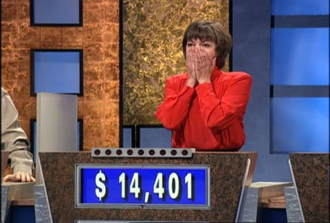 Jeopardy! contestant Nancy Zerg puts her hands to her mouth in shock after beating champion Ken Jennings in 2004.