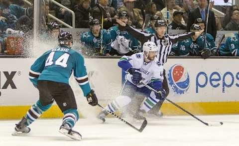 Mar 5, 2016; San Jose, CA, USA; Vancouver Canucks defenseman Matt Bartkowski (44) controls the puck against San Jose Sharks defenseman Marc-Edouard Vlasic (44) in the third period at SAP Center at San Jose. San Jose Sharks lose to Vancouver Canucks 2 to 4. Mandatory Credit: Neville E. Guard-USA TODAY Sports