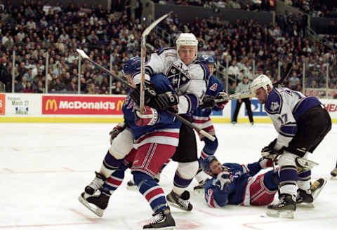 9 Mar 2000: Mattias Norstrom #14 of the Los Angeles Kings is hit by Michael York #18 of the New York Rangers at the Staples Center in Los Angeles, California. The Kings defeated the Rangers 3-1. Mandatory Credit: Kellie Landis /Allsport