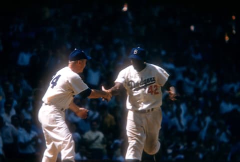 BROOKLYN, NY – JUNE 26: Jackie Robbinson #42 of the Brooklyn Dodgers is congratulated by manager Walter Allston #24 after hitting a homerun during an MLB game against the St. Louis Cardinals on June 26, 1954 at Ebbets Field in Brooklyn, New York. (Photo by Hy Peskin/Getty Images) (Set Number: X1434)