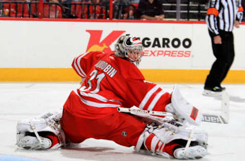 RALEIGH, NC – APRIL 05: Anton Khudobin #31 of the Carolina Hurricanes deflects a puck away during their NHL game against the New Jersey Devils at PNC Arena on April 5, 2014 in Raleigh, North Carolina. (Photo by Gregg Forwerck/NHLI via Getty Images)