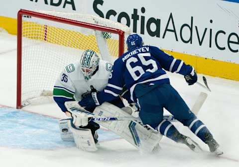 May 1, 2021; Toronto, Ontario, CAN; Toronto Maple Leafs right wing Ilya Mikheyev (65) charges the net as Vancouver Canucks goaltender Thatcher Demko (35) stops the puck during the second period at Scotiabank Arena. Mandatory Credit: Nick Turchiaro-USA TODAY Sports