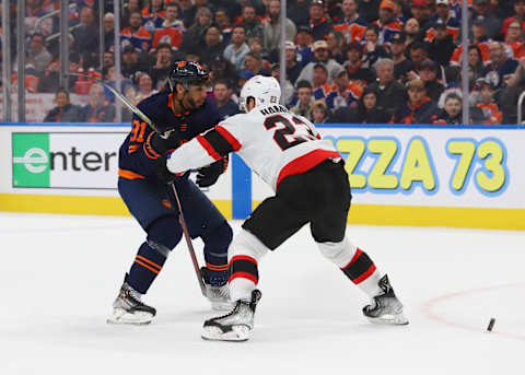 EDMONTON, CANADA – MARCH 14: Evander Kane #91 of the Edmonton Oilers battles for the puck with Travis Hamonic   (Photo by Lawrence Scott/Getty Images)