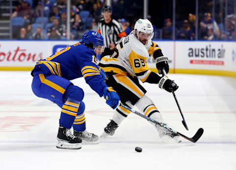 Oct 6, 2023; Buffalo, New York, USA; Buffalo Sabres center Peyton Krebs (19) tries to block a shoot in bt Pittsburgh Penguins defenseman Erik Karlsson (65) during the first period at KeyBank Center. Mandatory Credit: Timothy T. Ludwig-USA TODAY Sports