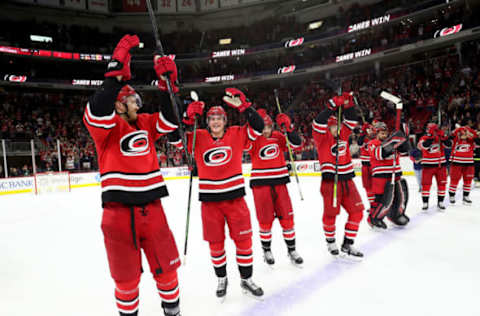 RALEIGH, NC – OCTOBER 29: Teammates of the Carolina Hurricanes celebrate a victory wth a Storm Surge during an NHL game against the Calgary Flames on October 29, 2019 at PNC Arena in Raleigh, North Carolina. (Photo by Gregg Forwerck/NHLI via Getty Images)