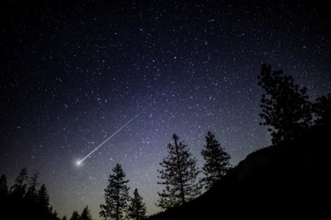 A night sky with a shooting star.