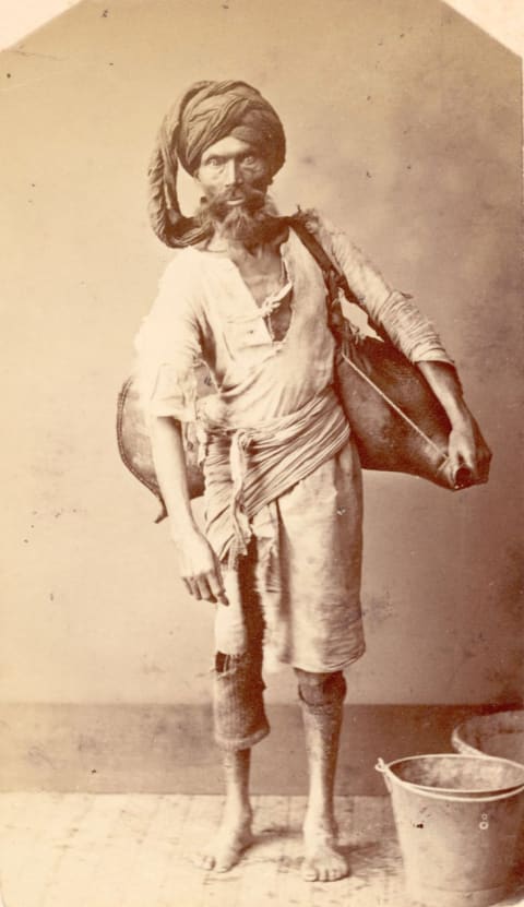 An Indian water carrier or "bhisti," circa 1870.