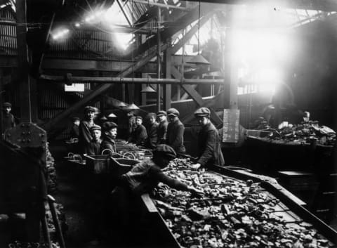 Young boys working the troughs in the mines of South Wales, circa 1910.