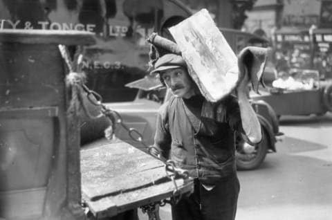 An iceman delivers blocks of ice in 1932.