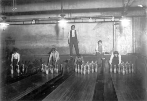 Pinsetters working in a bowling alley in Brooklyn, New York in 1910.