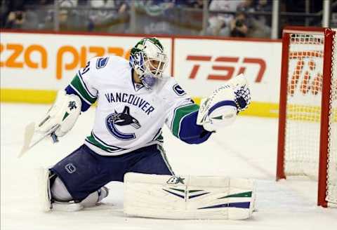 Jan 31, 2014; Winnipeg, Manitoba, CAN; Vancouver Canucks goalie Eddie Lack (31) makes a save against the Winnipeg Jets during the second period at MTS Centre. Winnipeg wins 4-3. Mandatory Credit: Bruce Fedyck-USA TODAY Sports