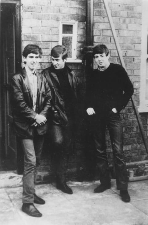 The Beatles standing outside Paul McCartney's Liverpool home circa 1960.